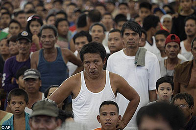 Stunned: Fans watch on in the Philippines as Pacquiao is beaten