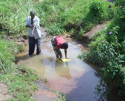 A woman drawing water. The New Times / File.