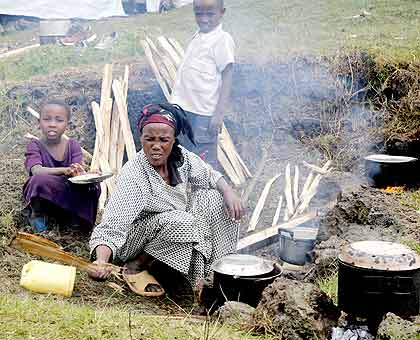 A refuge makes a meal at Nkamira refugee camp.