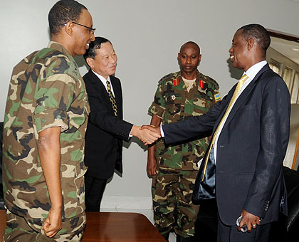 Defence Minister Gen. James Kabarebe (R) greets Japanese Ambassador to Rwanda Kunio Hatanaka at the Ministry of Defence on Monday. The New Times/John Mbanda.