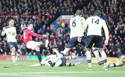 Robin van Persie scores the third goal during the match at Old Trafford yesterday