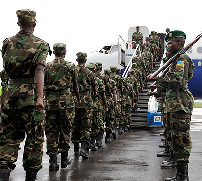 RDF soldiers board a Darfur-bound RwandAir Plane at Kigali International Air port in the past. The New Times / T.Kisambira.  