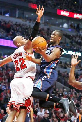 Charlotte Bobcats guard Kemba Walker (15) shoots past Chicago Bulls forward Taj Gibson (22) during the first half. Net photo.