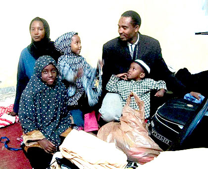 Muhammad Saeed poses with his wife Aliya and their children for their last photo in Pakistan before flying to Rwanda after over 20 years in exile.