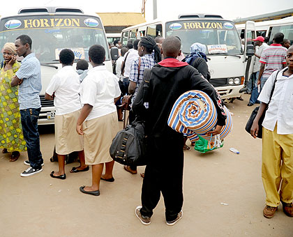 Students wait to board commuter buses in Nyabugogo taxi and bus park yesterday.  The New Times/ John Mbanda. 