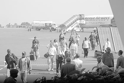 Tourists disembark from a plane at the Kigali International Airport; Online visas have eased entry into  the country