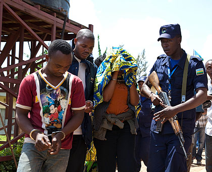 Three of the five suspects are led out of court yesterday. The New Times/Timothy Kisambira