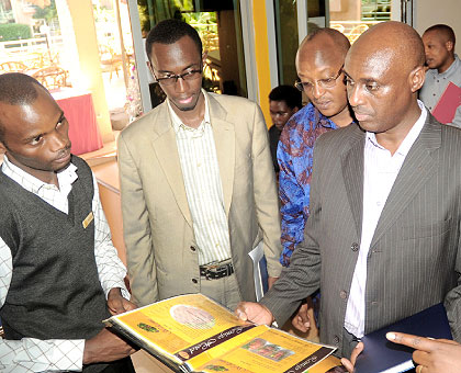 A team of the National Taskforce on Customer Care and Service Delivery, led by Gerald Mukubu (R), checks a menu at Lemigo Hotel in Kigali on Friday. The New Times/ J. Mbanda