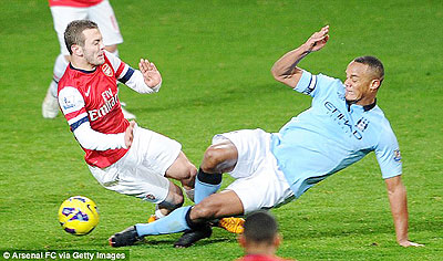 Vincent Kompany was sent off for this tackle on Jack Wilshere in the second half against Arsenal. Net photo.