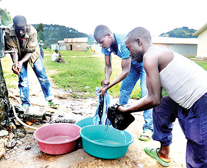 Clockwise, ex-Combatants wash clothes at Mutobo camp on Sunday, Rugwizangoga and Nshimiyimana.  The New Times/ John Mbanda.