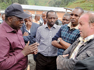 PM Habumuremyi talks to engineers at the power project last week. The New Times/ JP Bucyensenge