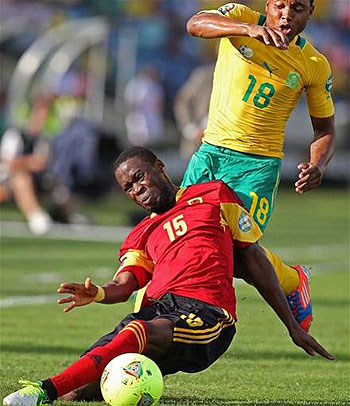 South Africau2019s Thuso Phala, (r) fights for the ball against Miguel Quiami during the Africa Cup of Nations game at the Moses Mabhida Stadium in Durban yesterday. Net photo.