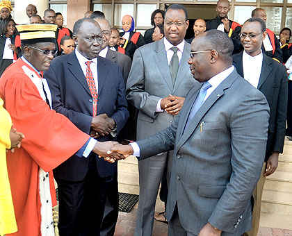 PM Habumuremyi (R) shakes hands with Prosecutor-General Martin Ngoga after the ceremony. Looking on are ministers Tharcise Karugarama (2ndL) of Justice and Protais Mitali of Culture.  The New Times/ J. Mbanda. 