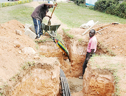 Workers lay Fibre Optic Cables in Kigali recently. A 2012 report says Internet access is still minimal across the country. The New Times/ File.