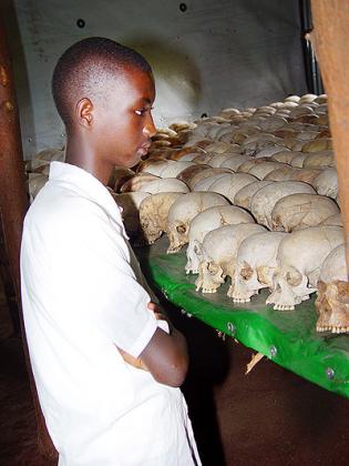 A young Genocide Survivor at a memorial site. The New Times / File.