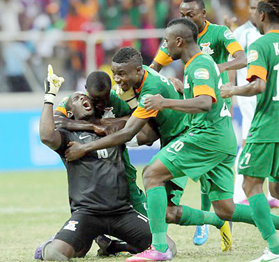 Zambia's goalkeeper Kennedy Mweene is congratulated by his teammates after scoring a penalty against Nigeria.  Net photo