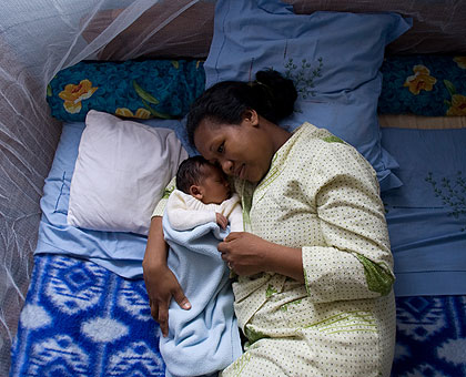 A mother and her child sleep under a mosquito net. Residents have been urged to embrace the use of nets. The New Times/ File