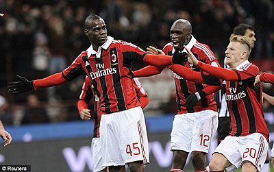 Balotelli is joined by his team-mates after rolling the winning penalty home. Net photo.