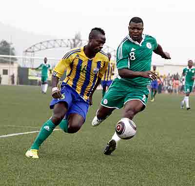 Influential defender Eric Gasana aka Mbuyu Twite (L), seen here in action against Nigeria during an Afcon 2013 qualifier last year, returns to the team having missed the last game against Angola. The New Times / File .