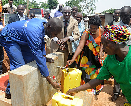 Kicukiro District Mayor Paul Jules Ndamage (in suit), together with Water for People coordinator Perpetue Kamuyumbu , join Masaka residents in inaugurating one of the water projects yesterday.  The district, in partnership with the Energy Water and Sanitation Authority  (EWSA) and Water for People Rwanda  inaugurated seven water and sanitation projects worth Rwf258 million in different villages. The New Times, John Mbanda.