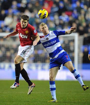 Man Unitedu2019s Michael Carrick and Pavel Pogrebnyak of Reading compete for the ball during the corresponding fixture at Madejski Stadium in December which United won 4-3. Net photo.