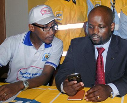 Youth and ICT Minister Jean Philbert Nsengimana (R) with RURA Director General at the launch of SIM card registration last month. The New Times / John Mbanda.