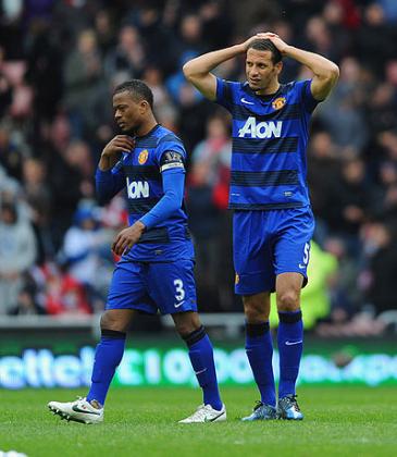 Manchester United Ferdinand and Evra leave the Sunderland ground last season disapointed after missing out on the title. Net photo.