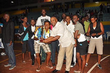 APR women players and officials celebrate after winning the playoff final trophy on Saturday.  Sunday Sport/ Plaisir Muzogeye.