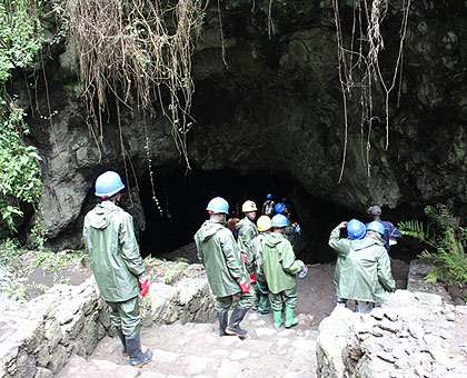 Tour operators at the caveu2019s entrance. The New Times/ JD Mbonyinshuti. 