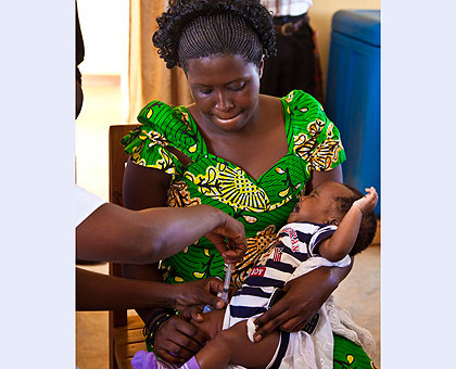 A child gets immunised at Busanza Health Centre. Immunisation averts an estimated 2-3 million deaths every year,  The New Times Timothy Kisambira