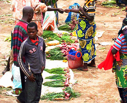 Vegetable sellers in Karambi market. Mobile phones helping connect farmers and buyers. The New Times/ JP Bucyensnege.