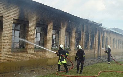 Fire fighters try to contain the fire.  The New Times/ Courtesy.