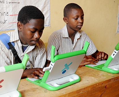 Pupils in Kigali busy with their OLPC laptops. The New Times/ File.