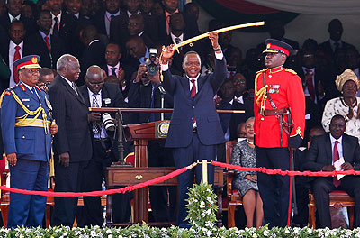  Kenyatta hoists the Commander-in-Chief ceremonial sword during the inauguration ceremony a fortnight ago. The New Times/ Agencies