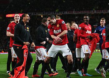 Rio Ferdinand tries to pull Robin van Persie's shorts down as they celebrated after winning the Premier League title at Old Trafford on Monday. Net photo.