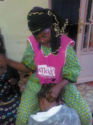 Mtengeti works on a client at her Nyamirambo salon. Although she is didnu2019t get formal education, she has achieved a lot as a home-trained hairdresser. The New Times / P. Tumwebaze