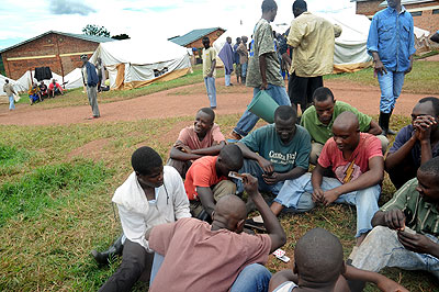 One of the ex-combantants play a game of cards at the  Ngoma Interment Camp. The New Times/John Mbanda. 