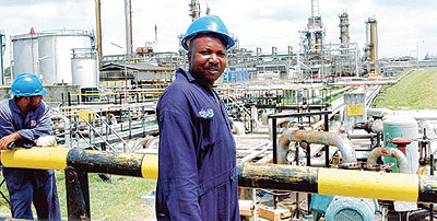 Workers at the Kenya oil refinery in Mombasa. The Kenya government and Essar are looking for funds to revamp the facility. New photo