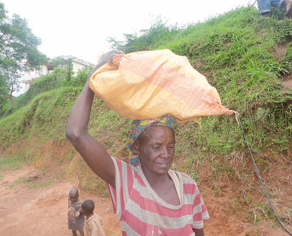 Nyinawintwari carries construction wares. The 70-year-old has maintained a tenacity to earn bread. The New Times/ Jean Pierre Bucysensenge.