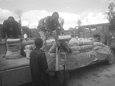 Workers offload cement at a site. The sectoru2019s demand for building materials is growing more than supply. The New Times / Moses Mekenye 