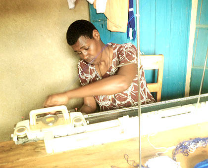 Uwizeye weaves threads through the needles in her sewing machine, while inset, she gets the appropriate thread colour to start of her sewing.   The New Times/ Laurent Kamana.