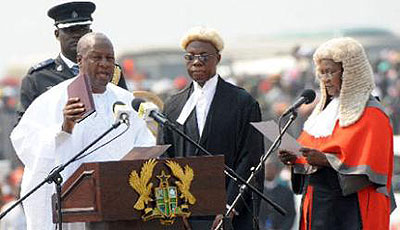 Mr John Dramani Mahama (L) takes an oath of office as Ghanau2019s President next to Chief Justice Georgina Wood (R), at the Independence Square, in Accra, January 7, 2013. The opposition has challenged the election results in court. Net photo.