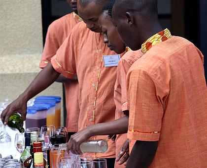 Waiters learning to mix cocktails.