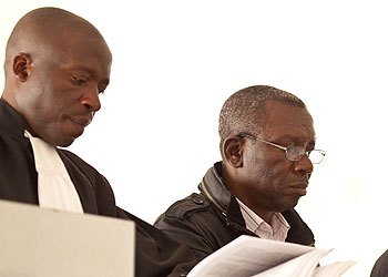 Bandora (left), flanked by his lawyers, during his bail hearing on Tuesday. The New Times/ File.