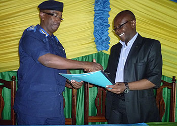 Nsabimana (L) exchanges treatise files with Bahame in Nyabihu District yesterday. The New Times/ Jean d'Amour Mbonyinshuti.