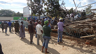 Grief-struck residents watch as rescuers try to find survivors trapped in the Nyagatare building collapse on Tuesday. The New Times /File.