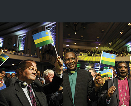 LEFT: Rwandans and well-wishers proudly wave the Sky-blue, Gold and Green National Flags, and right, Rwandan reverends show their solidarity at the function. At least 3,000 Rwandans and well-wishers converged for the event in which a panel of government and business leaders discussed development issues in motherland.  The New Times/ Courtesy.