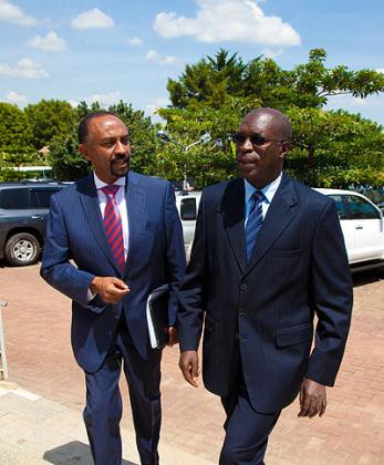 Gabriel Negatu, the regional Director of East Africa Resource Centre (L), chats with Anastase Murekezi, the minister for public service and labour yesterday.    The New Times/ Timothy Kisambira.