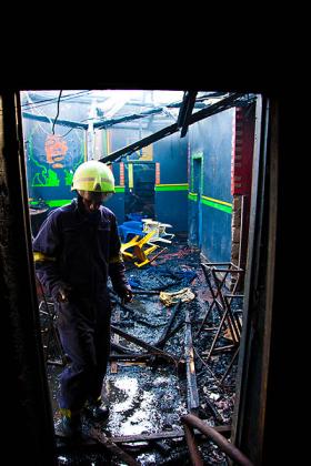 A fire fighter checks the damage after the fire was put out. The New Times/ T. Kisambira.