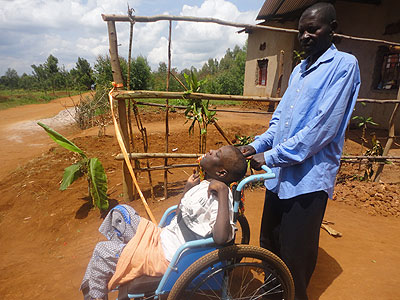 ABOVE: Habyarimana has looked after his disabled daughter for the last 18 years on her. LEFT: Kamonyi parents offer physical therapy to their disabled children during a week long training in physiotherapy.  The New Times/  Jean Pierre Bucyensenge